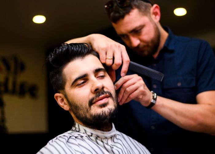 front-view-hairstylist-cutting-client-s-hair